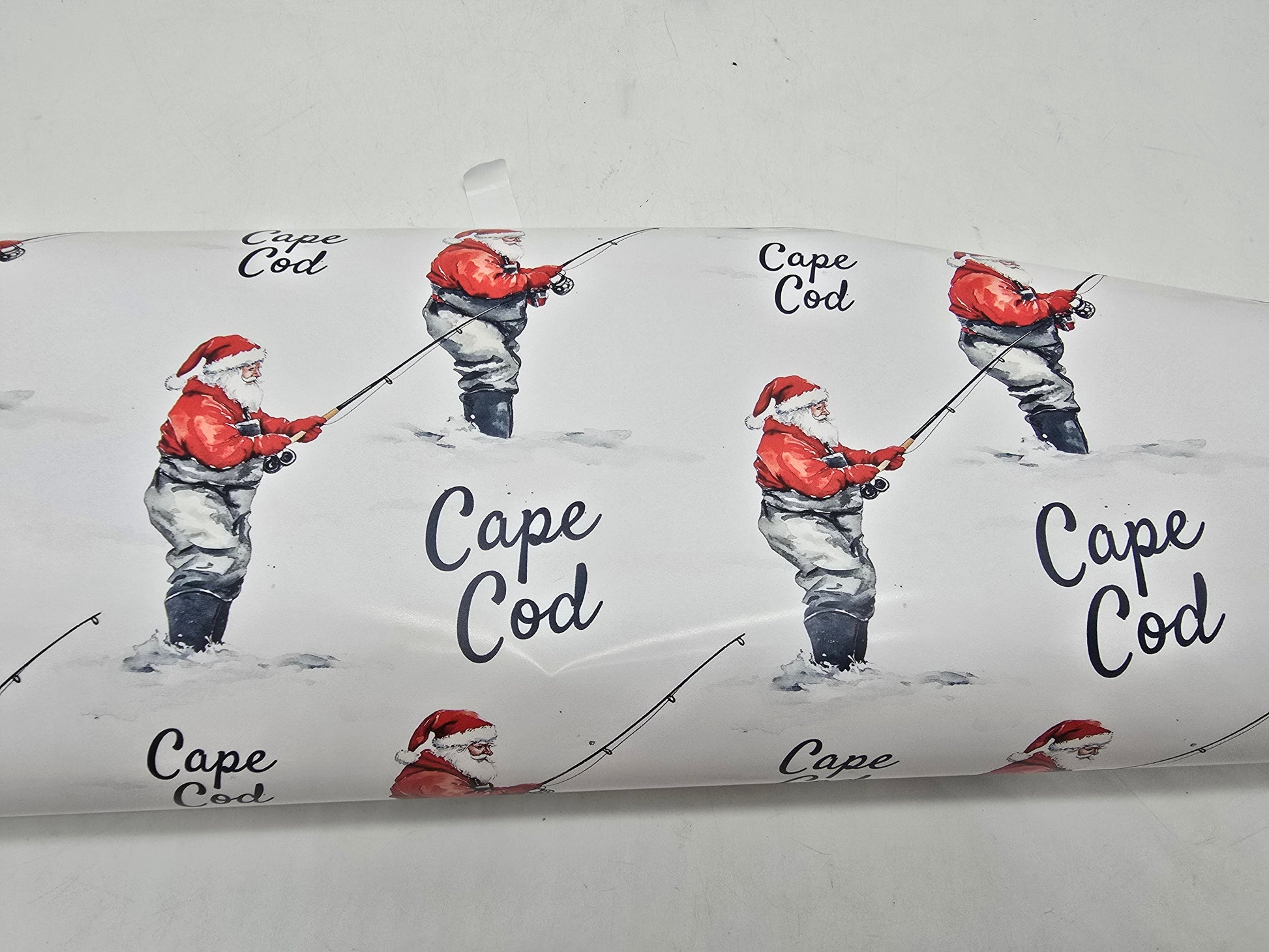 Cape Cod-themed wrapping paper with illustrations of a fisherman and 'Cape Cod' text.